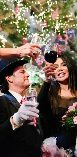 Ann and Stephen at the wedding drinking wine