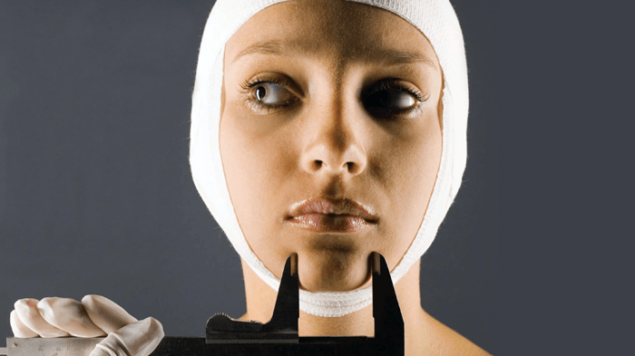 Woman with bandage wrapped around her face
